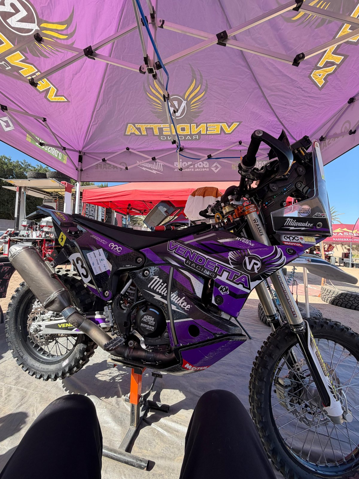 Race bike with full Vendetta Racing livery under the team tent at an event